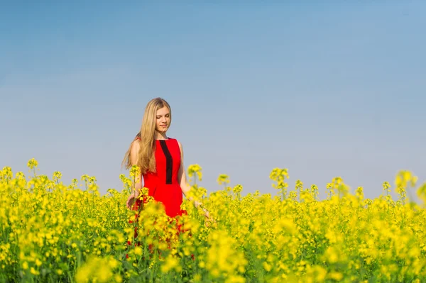 The girl in red is on the rape field.