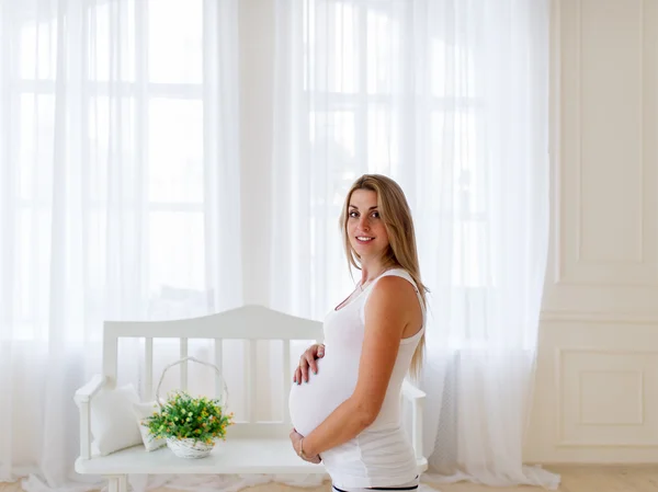 The pregnant woman is in the light room.