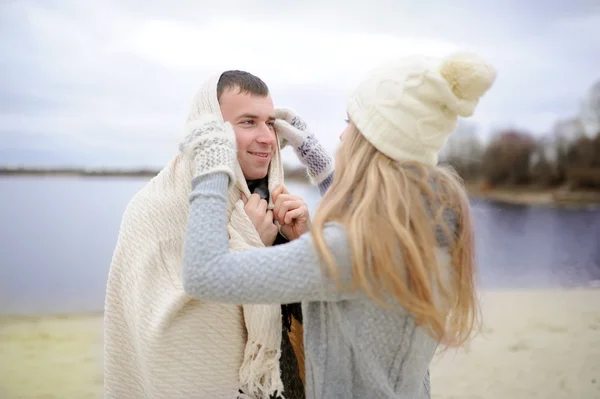 The guy and the girl walk on a desert autumn beach