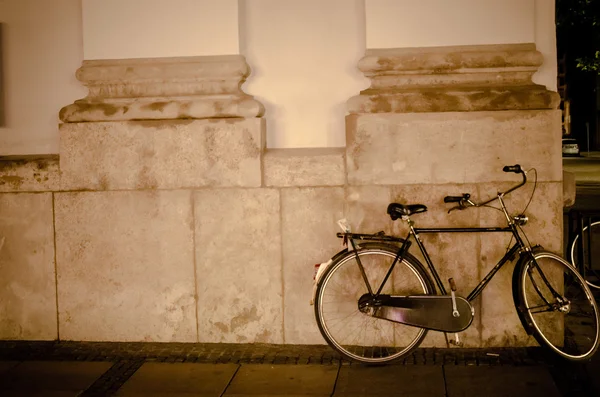 Night bicycle against city  light