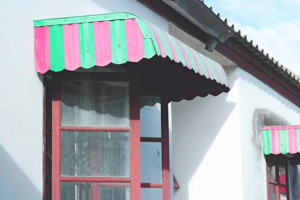 Red and green awning window