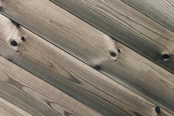 The aged brown planks. The wood texture. The background.