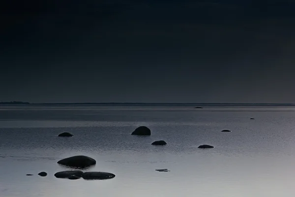 Cloudy dark minimalist seascape. Deserted space. Horizon line. Background.