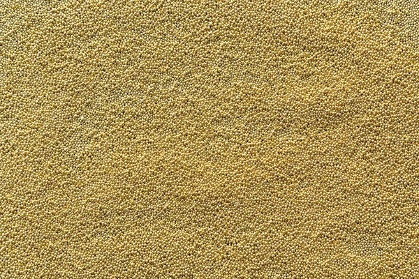 Abstract gold background with gold metal particles . The texture.