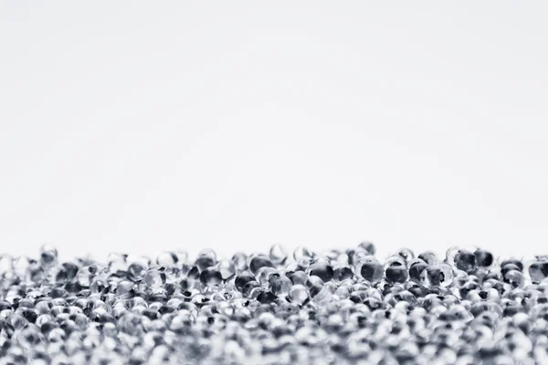 Minimalist abstract light background with transparent glass particles. The texture.