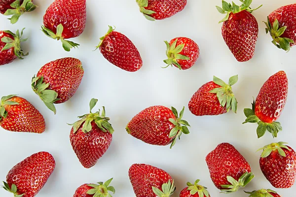 Strawberry background on white background.  Colorful ripe berries  strawberries. Fruit background. Strawberry pattern. Spring background. Summer background. Top view. Macro. Texture.