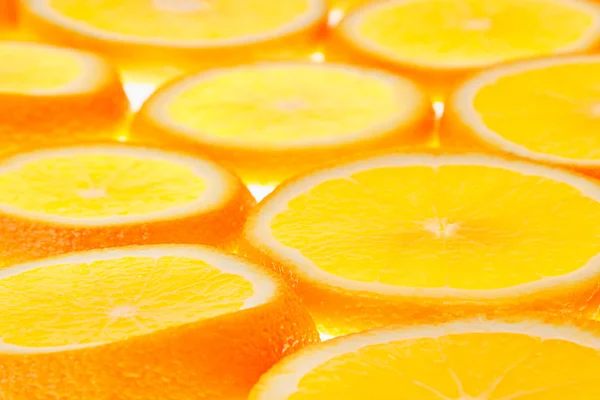 Glowing orange slices on a white background. Pattern. Fruit background.