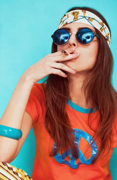 Boho girl portrait smoking weed and wearing sunglasses