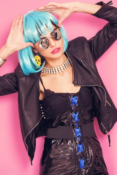 Odd girl portrait wearing blue wig and sunglasses