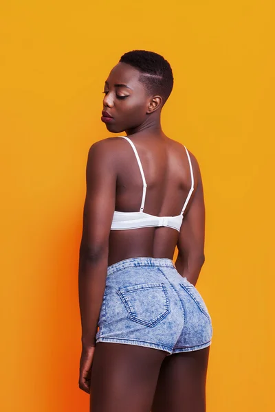 Pretty african girl back portrait wearing jeans shorts