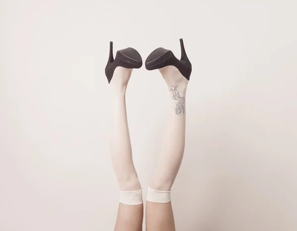 Female legs up in the air wearing heels