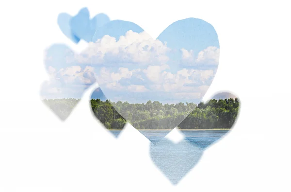Double exposure of paper hearts and lake landscape