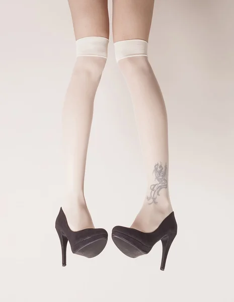 Female legs up in the air wearing heels