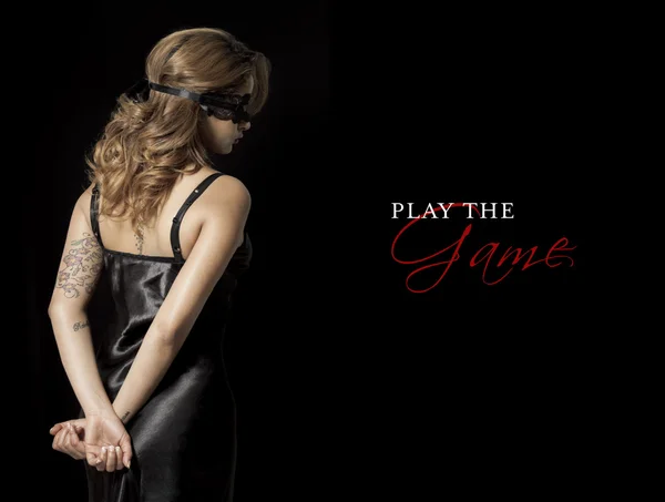 Blindfold woman with hands behind her back play the game