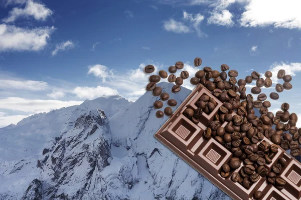 Winter mountain landscape with chocolate bar and coffee beans