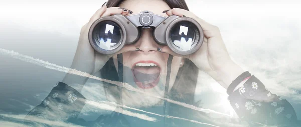 Double exposure of girl looking through binoculars and cloudscap