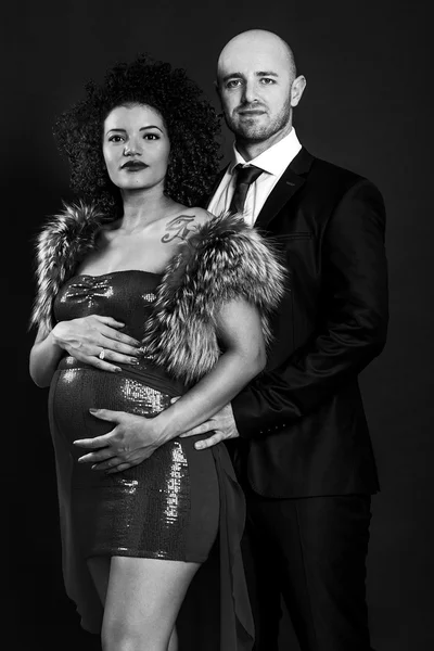 Beautiful and elegant pregnant couple black and white