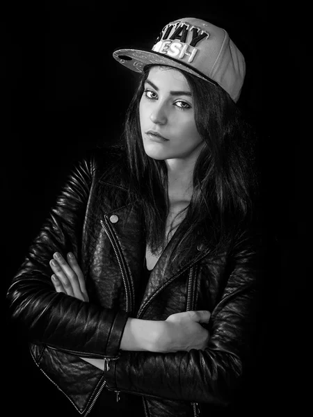 Beautiful girl wearing basket cap and leather jacket monochrome