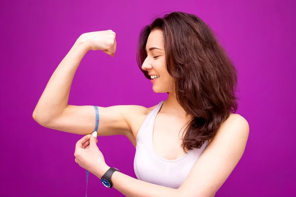 Fitness woman showing fresh energy flexing biceps muscles.