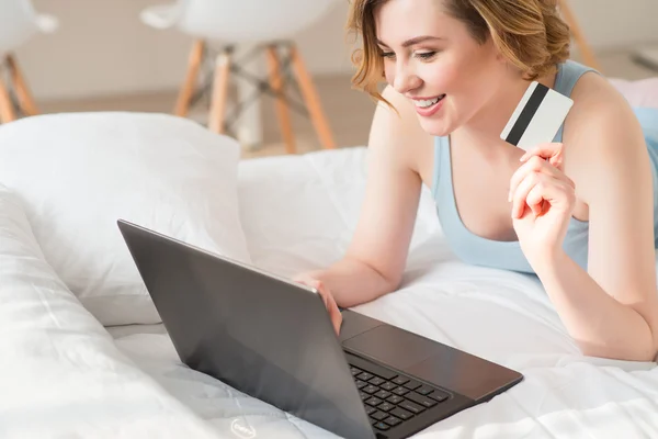 Positive girl using laptop