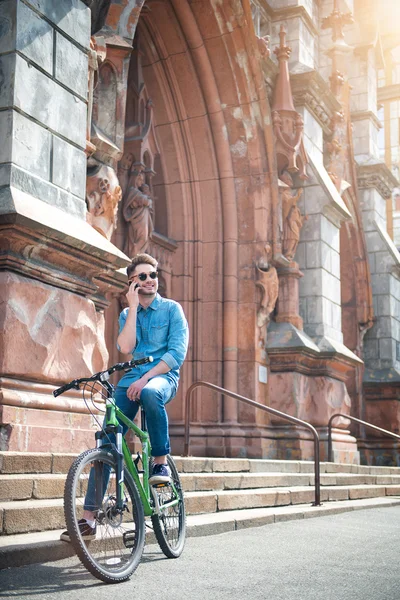 Positive guy sitting on the bicycle