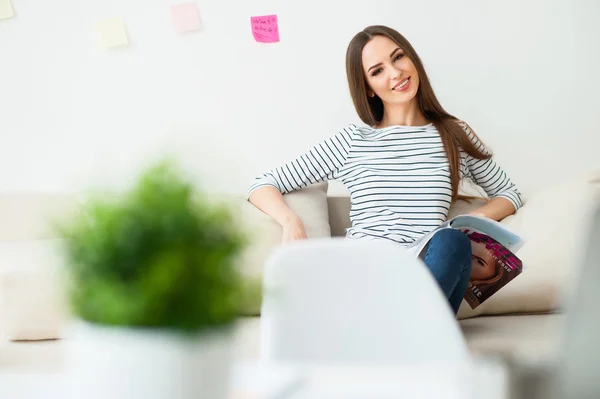 Positive woman  sitting on the couch