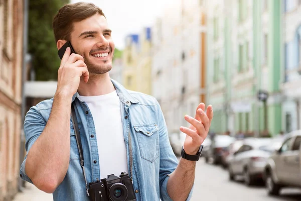 Cheerful man talking on cell phone.