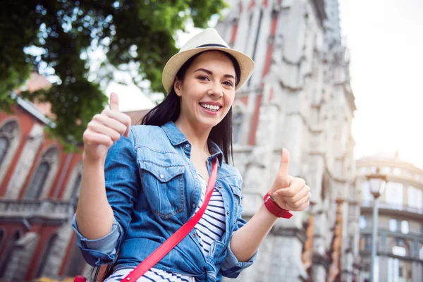 Cheerful woman thumbing up