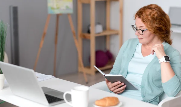 Pleasant woman holding note book