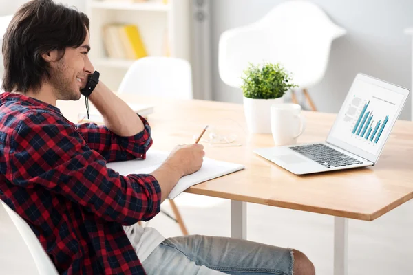 Cheerful man sitting at the table