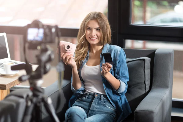 Positive woman shooting a video