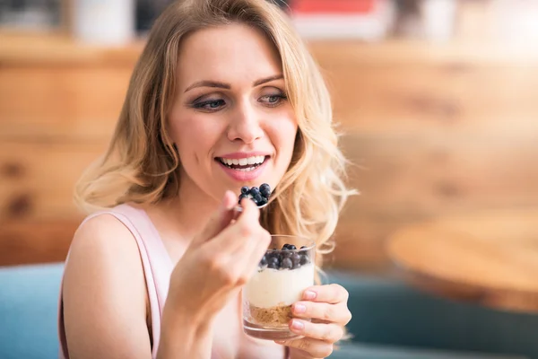 Nice young woman eating desert