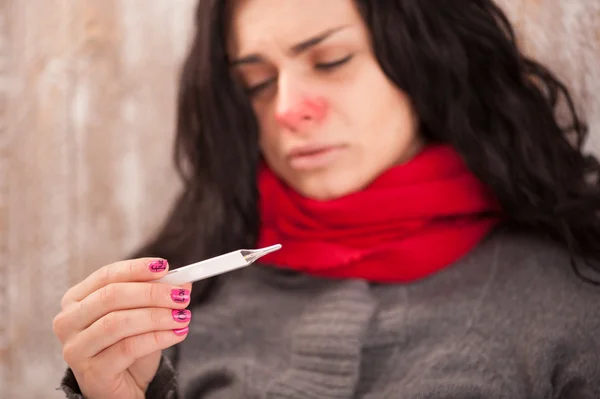 Desperate sick girl with thermometer