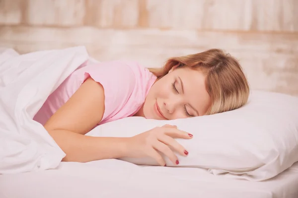 Young woman sleeping in bed