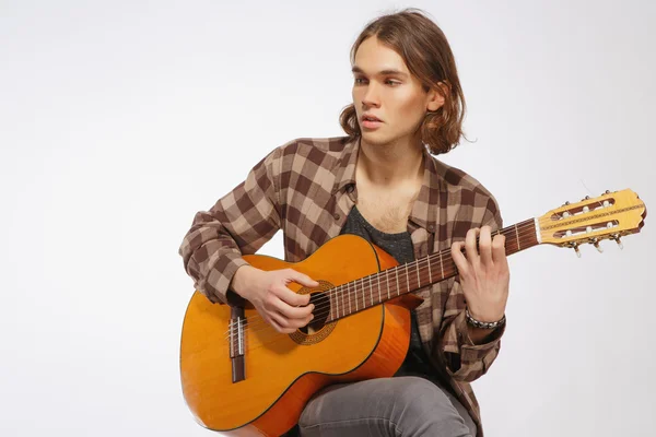 Young guitar player singing a song