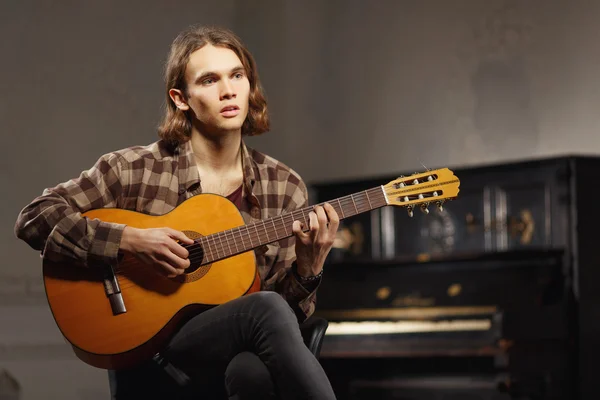 Young guitar player singing a song