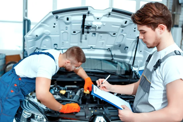 Car mechanics at the service station