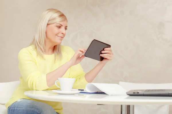 Woman watching at her tablet device