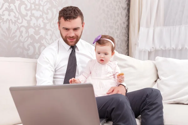 Handsome father working with laptop