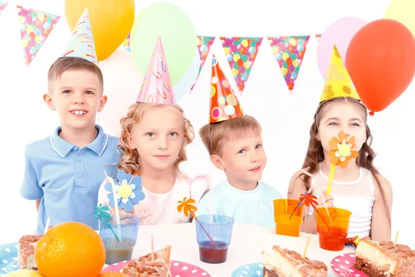Children posing with birthday party equipment