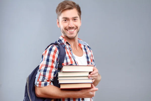 Positive student holding books