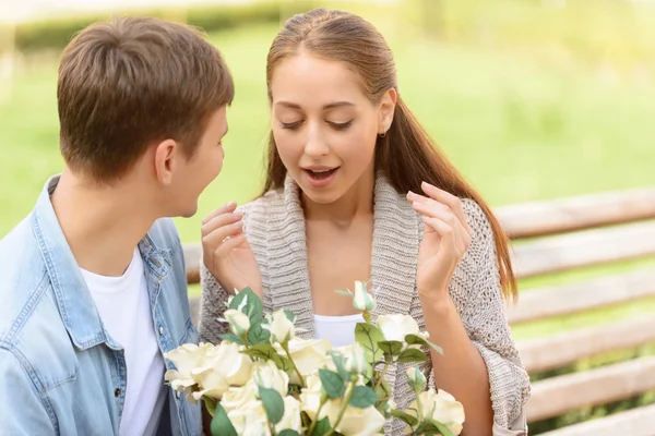 Boy presenting flowers to girl