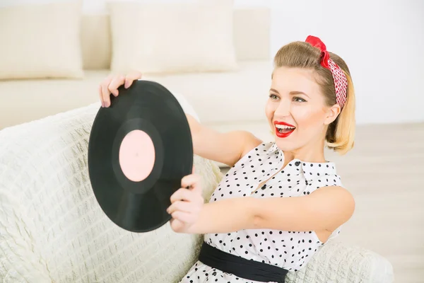 Pretty woman playing with vinyl record.