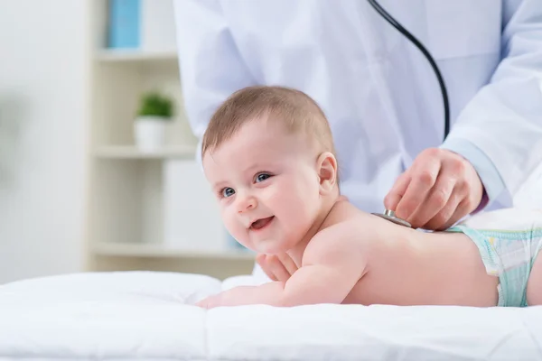 Professional pediatrician examining infant