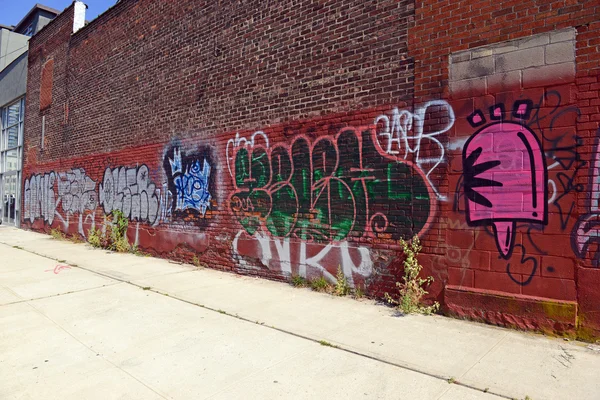 Graffiti shown on a city street in Brooklyn, New York USA