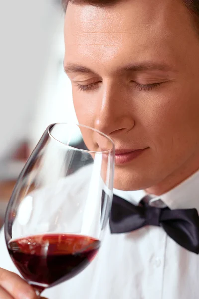 Professional sommelier tasting wine