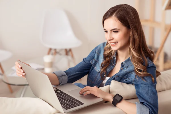 Cheerful girl using laptop