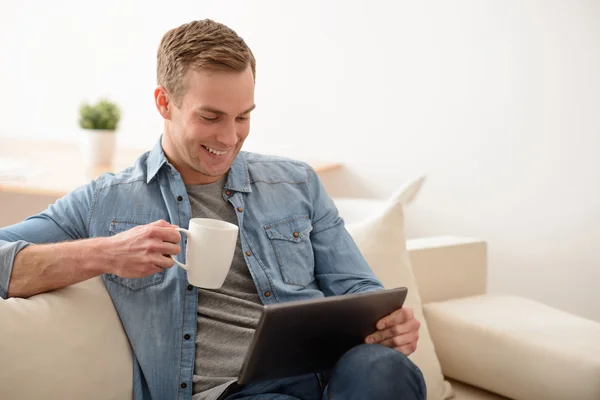 Pleasant man using tablet