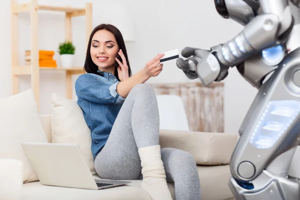 Girl giving credit card to the robot