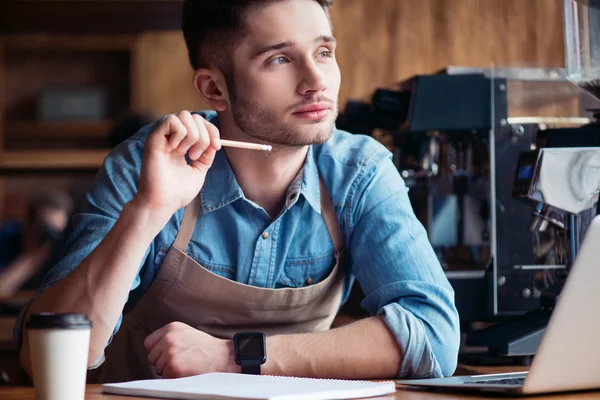 Pleasant barista making notes